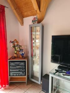 a room with a glass refrigerator and a television at Ferienwohnung Helga in Thalmässing