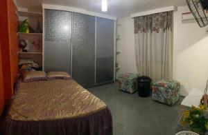 a bedroom with a bed in a room at Casa em Condomínio, Piscina Privativa e Área Gourmet in Camaçari