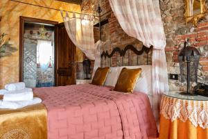 a bedroom with a large pink bed in a room at Luxury Corte Di Re Artù in Lucca