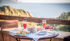 a table with food and drinks on top of a table at Hotel Monte Turri by Falkensteiner in Àrbatax +52 photos