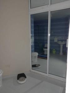 baño blanco con aseo y ventana en casa equipada estadia placentera, en Hainamosa