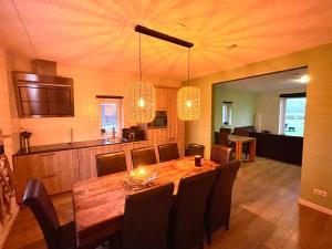 a dining room with a wooden table and chairs at B&B Hof 't Sprakel in Haaksbergen