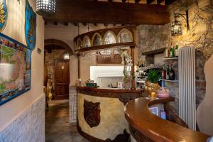 a kitchen with a bar in a room at Luxury Corte Di Re Artù in Lucca