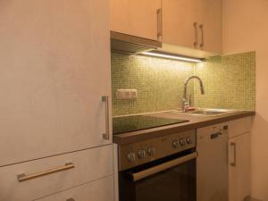 a kitchen with a sink and a stove at Ferienwohnung Alpenglück in Garmisch-Partenkirchen +18 photos