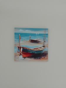 a painting of a boat on the beach at Sea life Terrasini in Terrasini