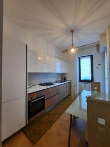 a kitchen with a stove and a table in it at La Dama dei Fiori in Vimercate