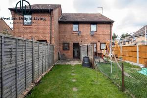 a brick house with a fence and a yard at Dwellers Delight Living Ltd Serviced accommodation 2 Bed House, free Wifi & Parking, Prime Location London, Woodford in Woodford Green