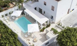 an aerial view of a white building with a swimming pool at Il Moro Camere&Relax in San Vito lo Capo
