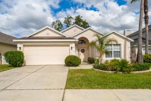 a house with a garage and a palm tree at 124DORN-Highlands Villa (S) in Davenport