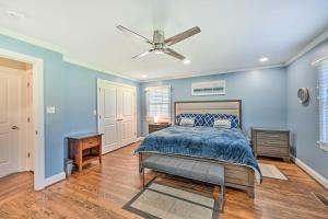 a blue bedroom with a bed and a ceiling fan at Ranch-Style Home 7 Mi to Downtown Greensboro! in Greensboro