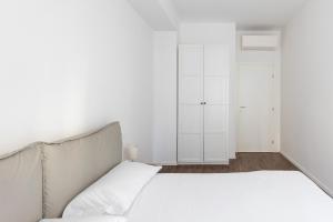 En eller flere senge i et værelse på Largo Molina Apartment 1 by Wonderful Italy