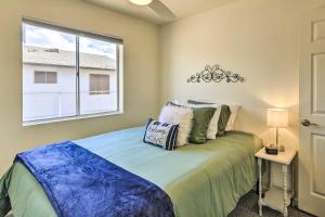 a bedroom with a large bed with a window at Kingman Vacation Rental with Yard and Fire Pit in Kingman