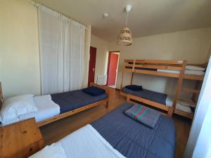 a room with two beds and two bunk beds at Les Pastourelles in Capbreton +122 photos