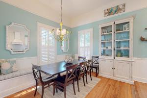 a dining room with a wooden table and chairs at True Knot Cottage in Saint Simons Island