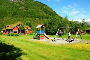 a group of people playing on a playground at Bøyum Camping in Fjarland