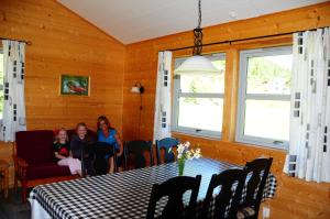 two women sitting at a table in a dining room at Bøyum Camping in Fjarland