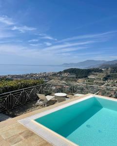 a swimming pool on top of a house at Villa Gaia - Luxury Villa, pool & wellness rooms in Bordighera