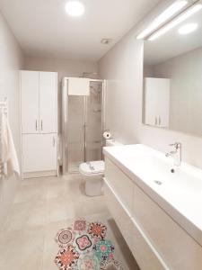 a bathroom with a sink toilet and a shower at Apartamento PATXIKE con plaza de garaje in Bermeo