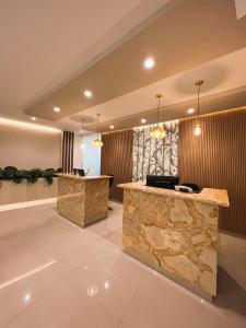 a lobby with two reception desks in a building at Oasis Hotel in San Andrés