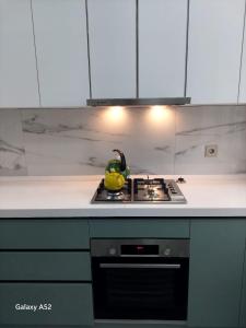 a kitchen with a stove with a yellow duck on it at Luxury Guest House in Sumqayyt