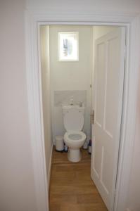 a bathroom with a white toilet in a doorway at Two Bedroom Flat in London in London