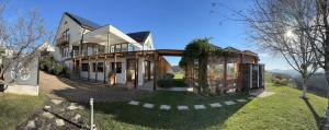 a large house with a porch on a green yard at B&B Villa Angelina in Rogaška Slatina