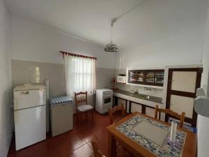 una cucina con tavolo, frigorifero, tavolo e sedie di Casa Las Indias a Las Indias