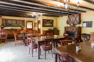 a dining room with wooden tables and chairs at Hotel Nomad Belvedere Lodge in Midrand