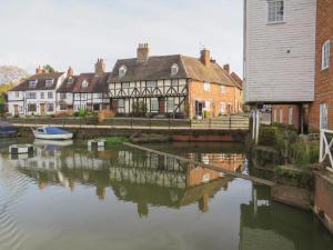 a group of houses next to a body of water at Runnymede in Tewkesbury