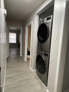 a room with two microwaves hanging on a wall at Cozy, Fam Friendly Home Min from Stkyards in Fort Worth