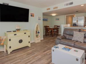 a living room with a couch and a flat screen tv at Laguna Reef #413 - Waters Edge in Rockport