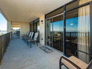 a balcony with chairs and a view of the ocean at Laguna Reef #413 - Waters Edge in Rockport +34 photos