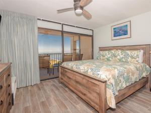 a bedroom with a bed and a balcony at Laguna Reef #413 - Waters Edge in Rockport +32 photos