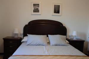 a bedroom with a large bed with two night stands at Piso da Horta en Aguiño, Ribeira, Galicia in Ribeira