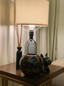 a table with a lamp and a glass cat on it at Out of Mood ! luxury stay!! Abu Dhabi Yas Island in Abu Dhabi