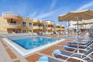 a swimming pool with chairs and an umbrella at La Mar 2 bed 2 bath in sought after position FREE WIFI in Puerto de Santiago