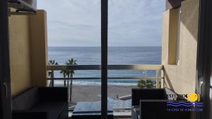 a view of the ocean from the balcony of a hotel at ESTUDIOS ChinaSOL in Almuñécar