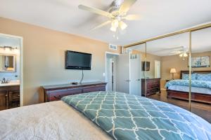 a bedroom with a bed and a flat screen tv at Upscale Sun City Home on South Golf Course in Sun City