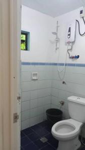 a bathroom with a toilet and a shower at Sea the Waves Transient House in Dalumpinas Oeste