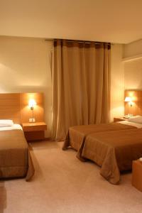 Ένα ή περισσότερα κρεβάτια σε δωμάτιο στο Deves Hotel 
