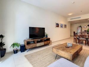 a living room with a large flat screen tv at Key View - Elite Residence in Dubai