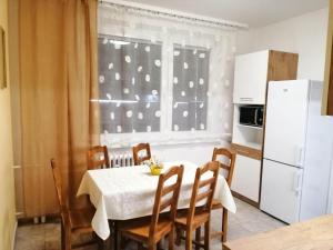 a kitchen with a table and chairs and a window at Apartmán West in Poprad