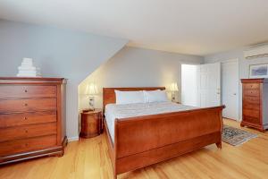 a bedroom with a bed and a wooden dresser at Green Mountain Manor in Waterbury Center