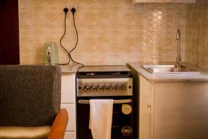 a kitchen with a stove and a sink at Hecasa Homestay in Arusha