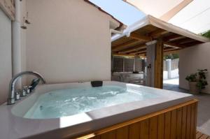 a jacuzzi tub in a yard with a patio at Angel luxury villa in Petrití