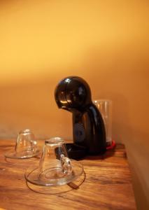 two glasses sitting on top of a wooden table at Hotel Scappata in Progreso
