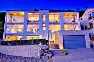 a large house with a garage in front of it at Spectacular Panoramic 5Bedroom Lakeview in Queenstown