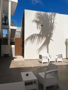 a shadow of a palm tree on the side of a building at Oasis Hotel in San Andrés