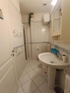 a white bathroom with a sink and a toilet at Civico1280 Holiday in Camaiore
