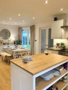 a kitchen with a kitchen island with a table in it at South Downs View in West Meon